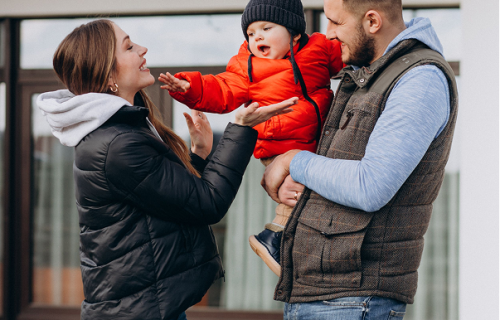 young-family-with-little-son-by-house 2
